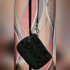 Coach Signature C black canvas wristlet with black leather trim.